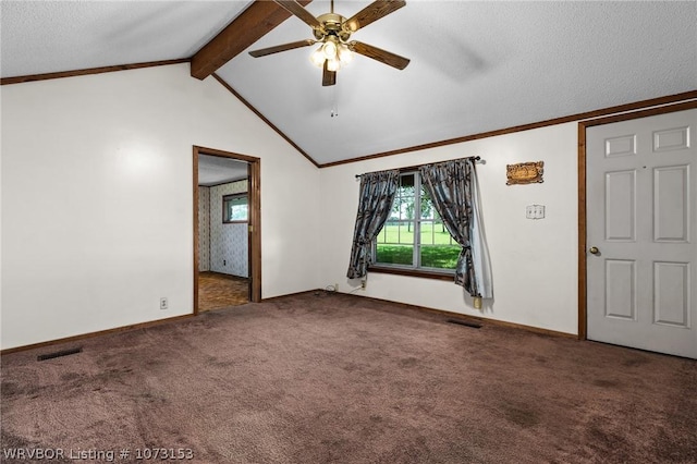 empty room with ceiling fan, carpet floors, lofted ceiling with beams, and a textured ceiling