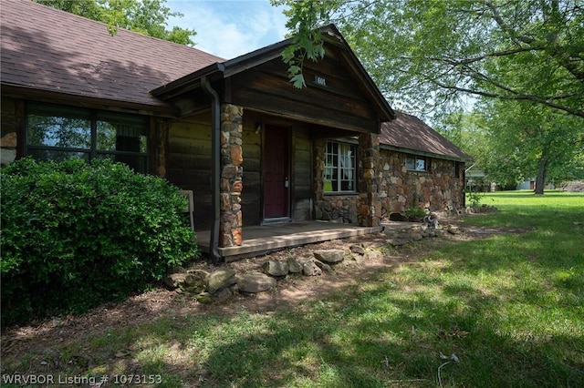 entrance to property featuring a yard