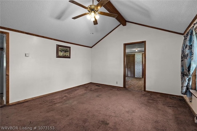 carpeted empty room featuring a textured ceiling, lofted ceiling with beams, and ceiling fan