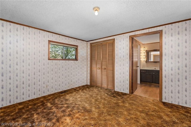 unfurnished bedroom featuring light carpet, ensuite bathroom, and ornamental molding