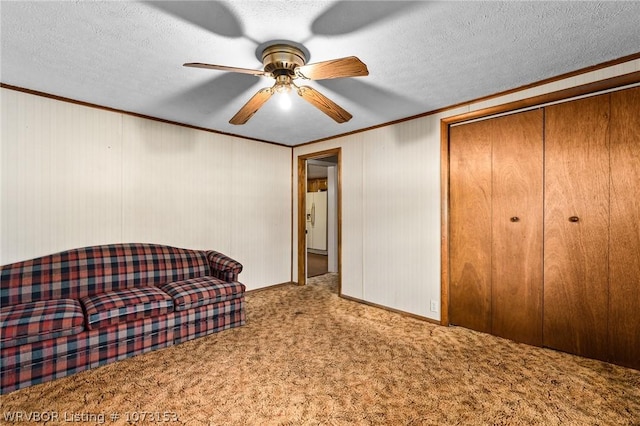 unfurnished room with carpet, ceiling fan, crown molding, and a textured ceiling