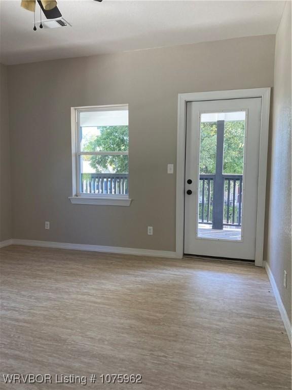 interior space featuring light hardwood / wood-style flooring and ceiling fan