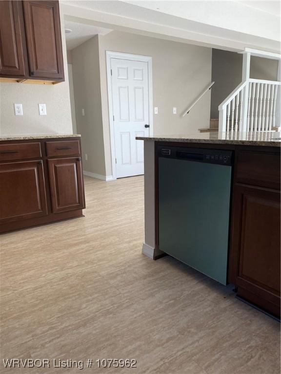 kitchen featuring dark brown cabinetry, light stone countertops, dishwasher, and light hardwood / wood-style floors