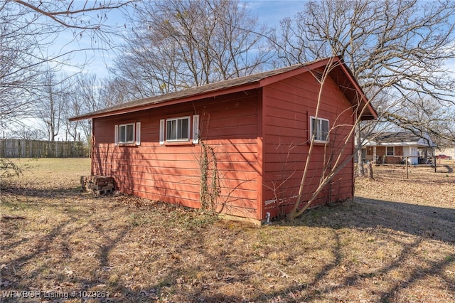 view of outbuilding with an outbuilding and fence