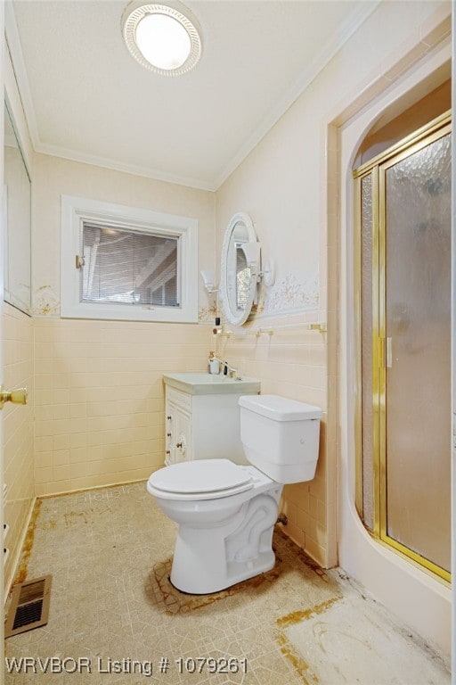 full bath featuring a shower stall, crown molding, visible vents, and tile walls