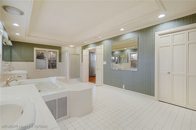 bathroom with a sink, a raised ceiling, and wallpapered walls