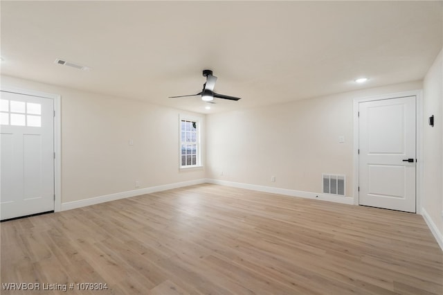 interior space with light wood-type flooring, baseboards, and visible vents