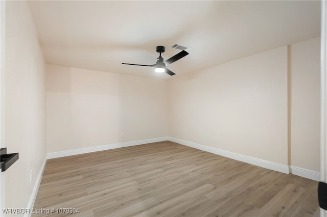 spare room with baseboards, ceiling fan, visible vents, and light wood finished floors