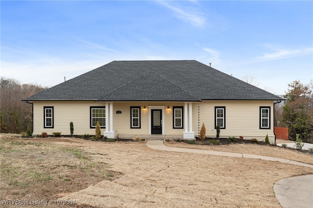 view of front of property featuring a shingled roof and covered porch