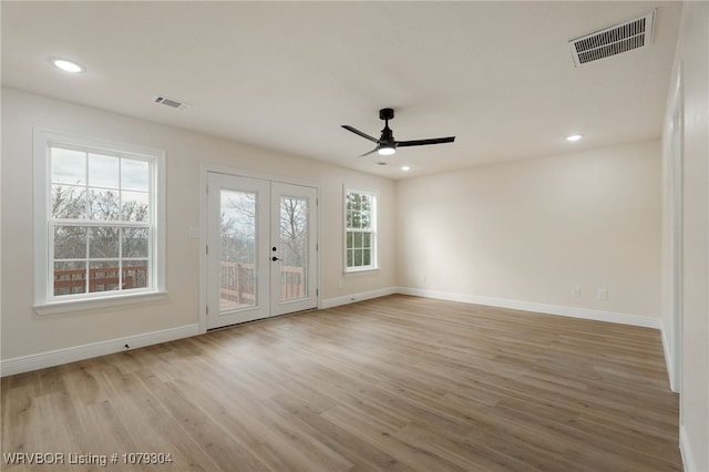 spare room featuring french doors, wood finished floors, visible vents, and recessed lighting