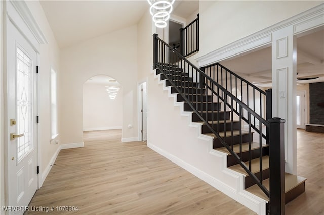 foyer entrance featuring baseboards, a healthy amount of sunlight, and light wood finished floors