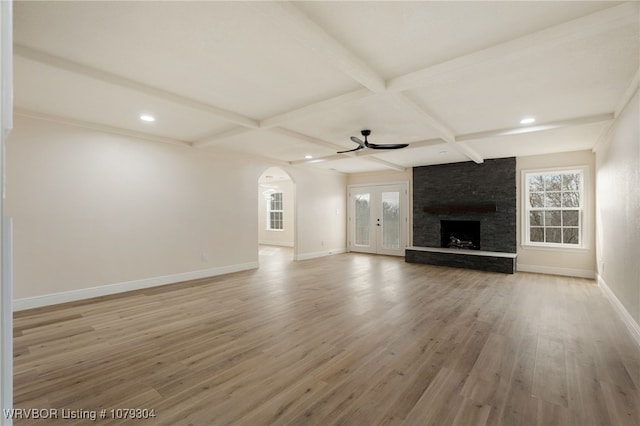 unfurnished living room featuring light wood-type flooring, a fireplace, baseboards, and coffered ceiling