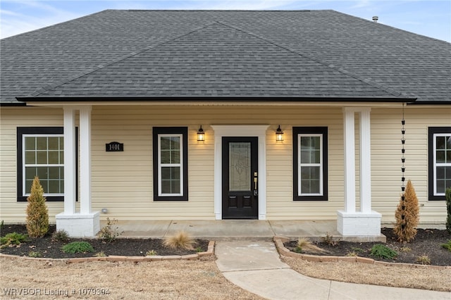 bungalow featuring a shingled roof and a porch