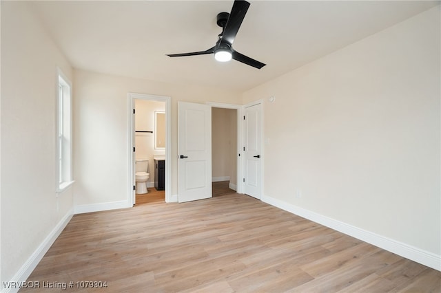 unfurnished bedroom with a ceiling fan, light wood-type flooring, baseboards, and ensuite bathroom