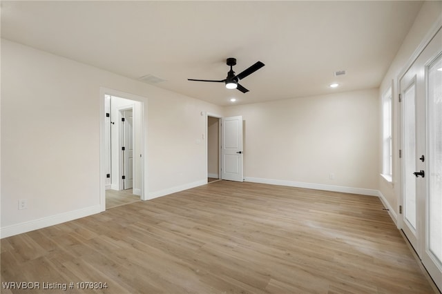 empty room featuring light wood finished floors, recessed lighting, visible vents, a ceiling fan, and baseboards