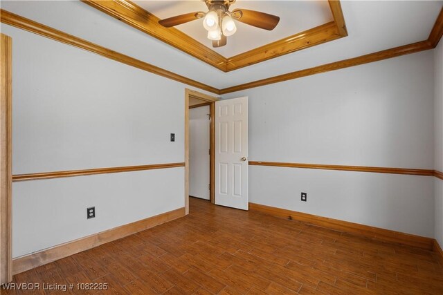 3017 Canongate Way, Fort Smith, AR 72908 - unfurnished room with a raised ceiling, ceiling fan, crown molding, and wood finished floors