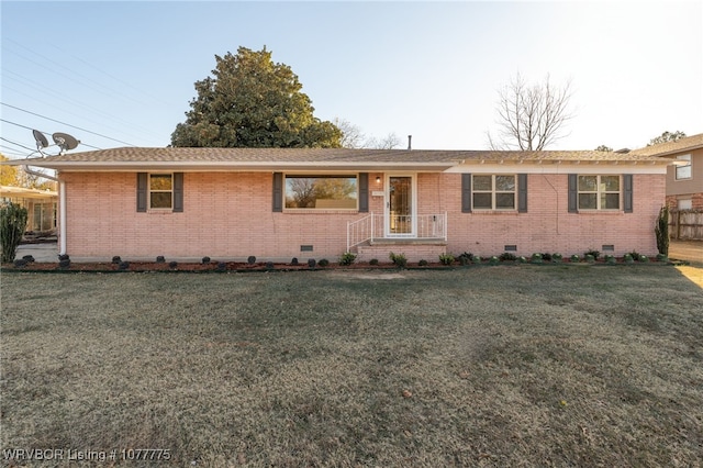 ranch-style home with a front lawn