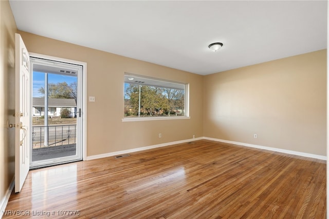 empty room featuring hardwood / wood-style flooring