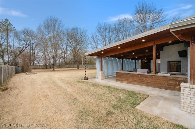 view of yard with a patio, a bar, and a fenced backyard