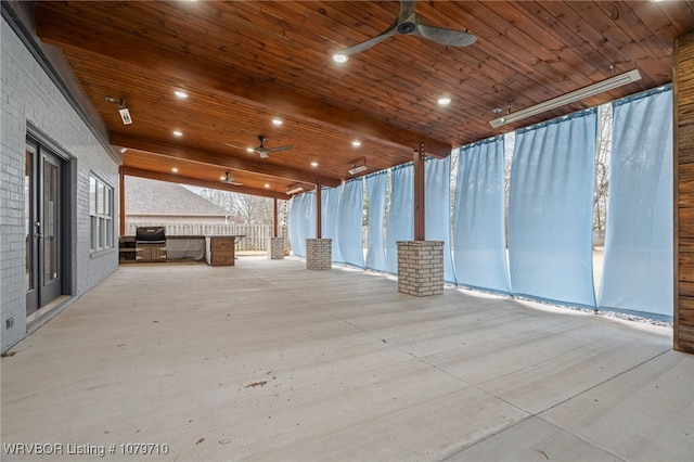 exterior space featuring area for grilling, ceiling fan, and exterior kitchen