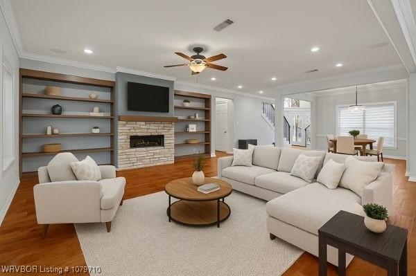 12200 Stonechase Dr, Fort Smith, AR 72916 - living area with crown molding, wood finished floors, ceiling fan, a fireplace, and recessed lighting
