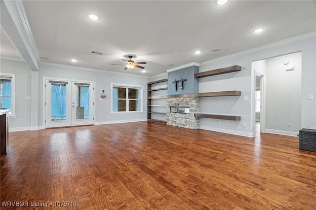 unfurnished living room with dark wood finished floors, visible vents, ceiling fan, and baseboards