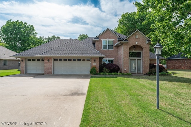 traditional-style house with brick siding, roof with shingles, a front yard, concrete driveway, and an attached garage