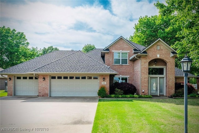 12200 Stonechase Dr, Fort Smith, AR 72916 - traditional-style house with a front yard, an attached garage, concrete driveway, brick siding, and french doors