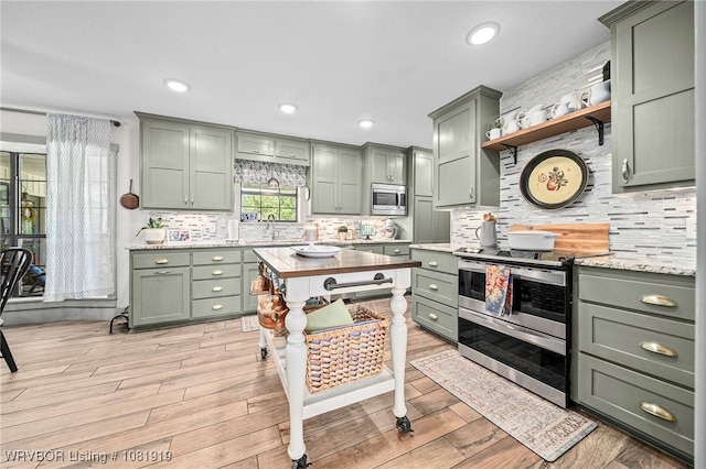 8807 Cain Rd, Alma, AR 72921 - kitchen featuring green cabinets, appliances with stainless steel finishes, tasteful backsplash, open shelves, and recessed lighting
