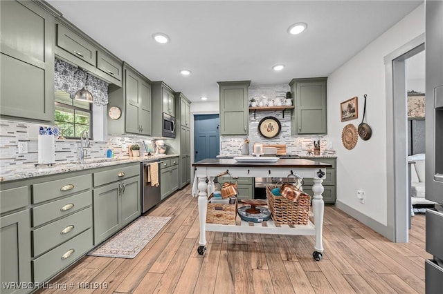 8807 Cain Rd, Alma, AR 72921 - kitchen with green cabinets, backsplash, stainless steel appliances, light wood-type flooring, and recessed lighting