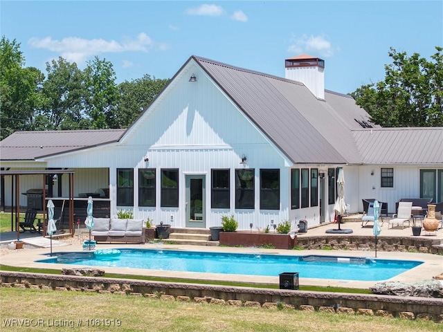 8807 Cain Rd, Alma, AR 72921 - back of property featuring an outdoor living space, a patio, an outdoor pool, and a chimney
