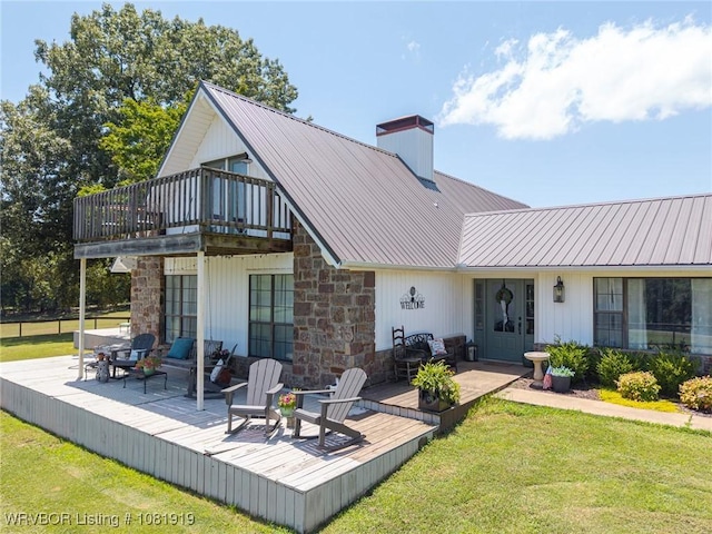 8807 Cain Rd, Alma, AR 72921 - back of property featuring a deck, stone siding, and a chimney