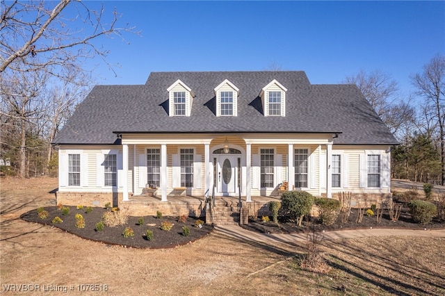 cape cod-style house with covered porch