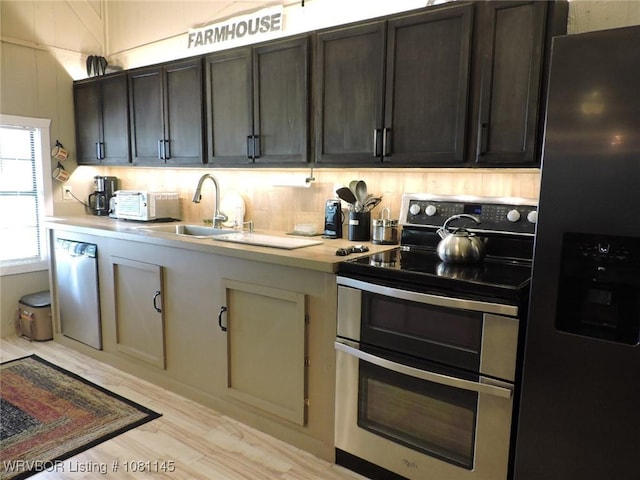19108 Canova Trl, Mountainburg, AR 72946 - kitchen featuring stainless steel appliances, light countertops, a sink, light wood-style floors, and dark brown cabinets