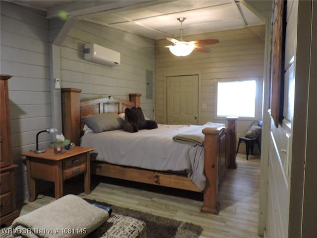 19108 Canova Trl, Mountainburg, AR 72946 - bedroom with an AC wall unit, light wood-style floors, and wooden walls