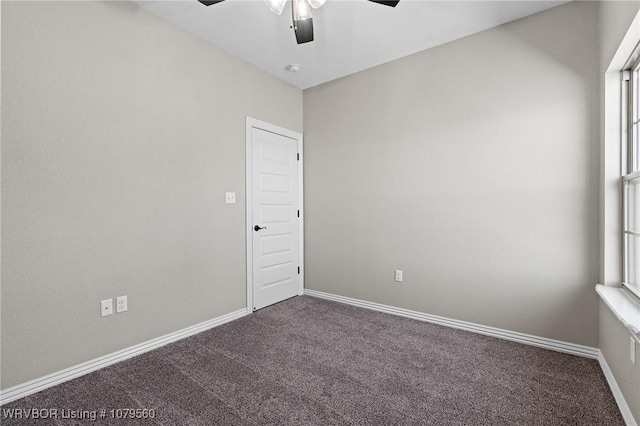 spare room featuring baseboards, carpet floors, and a ceiling fan