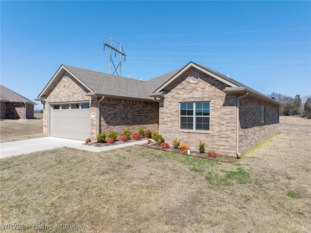 ranch-style home featuring brick siding, concrete driveway, a front yard, roof with shingles, and a garage