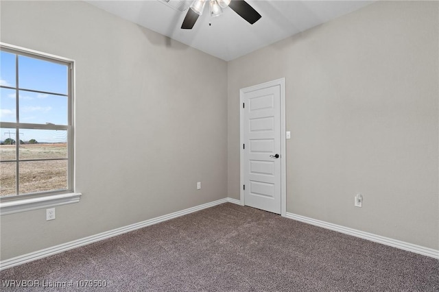 empty room featuring carpet flooring, a ceiling fan, and baseboards