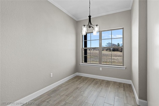 empty room featuring baseboards, an inviting chandelier, crown molding, a textured wall, and light wood-type flooring