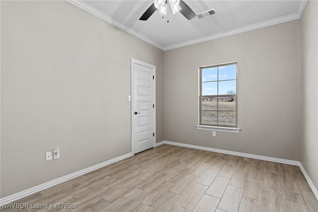 empty room with light wood-type flooring, visible vents, crown molding, baseboards, and ceiling fan