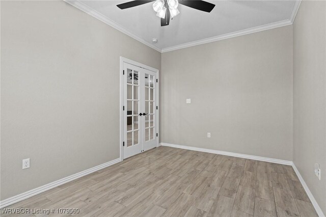 spare room with ornamental molding, french doors, light wood finished floors, baseboards, and ceiling fan