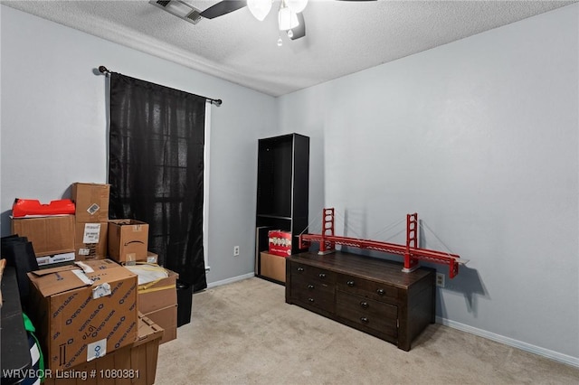 interior space with baseboards, visible vents, a textured ceiling, and ceiling fan
