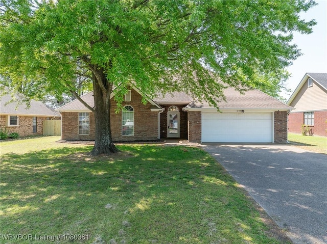 view of front of property with brick siding, an attached garage, aphalt driveway, and a front lawn