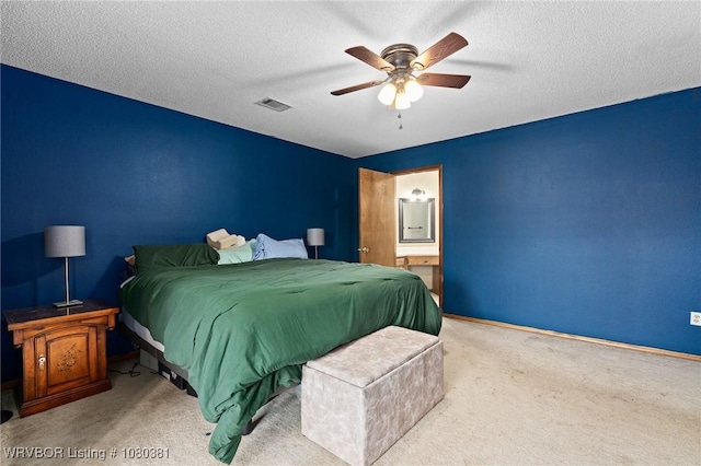 bedroom featuring a ceiling fan, a textured ceiling, connected bathroom, carpet, and visible vents