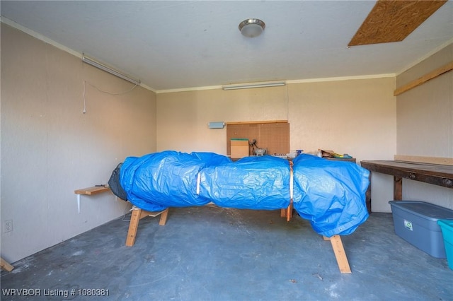 bedroom featuring concrete floors and crown molding