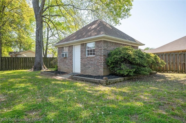 view of outbuilding with a fenced backyard and cooling unit