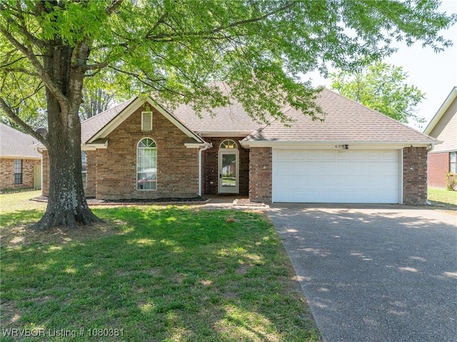 view of front of property with aphalt driveway, roof with shingles, an attached garage, brick siding, and a front yard