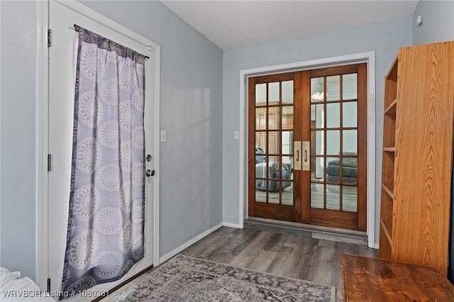 doorway to outside featuring baseboards, french doors, and wood finished floors