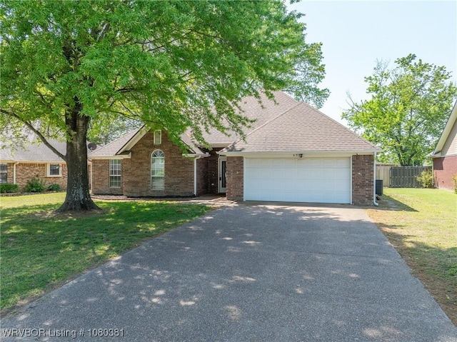 view of front of home with fence, an attached garage, aphalt driveway, and brick siding