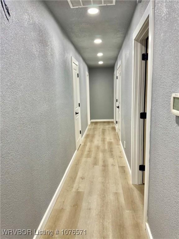 hallway featuring light hardwood / wood-style flooring